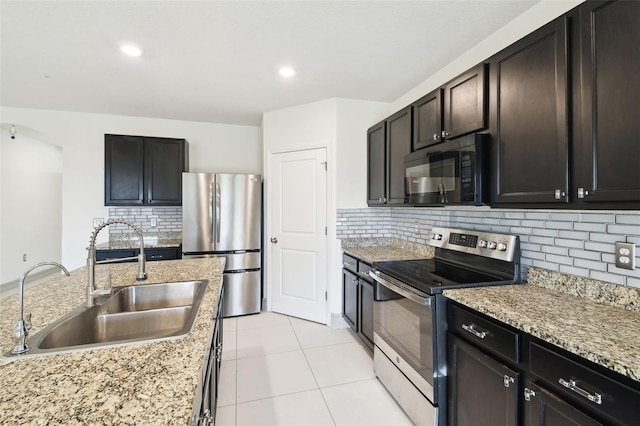 kitchen featuring a sink, light tile patterned flooring, stainless steel appliances, backsplash, and recessed lighting