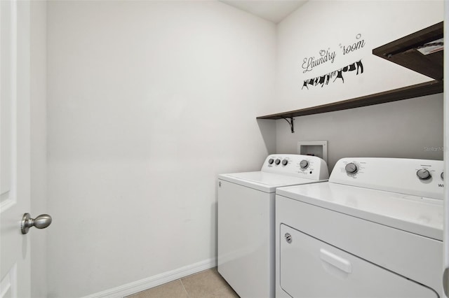 laundry room with washing machine and dryer, laundry area, baseboards, and light tile patterned floors