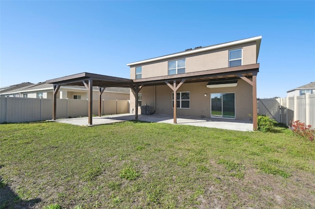 rear view of property featuring a patio area, a fenced backyard, a lawn, and stucco siding