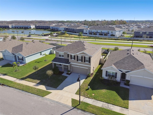 birds eye view of property featuring a water view and a residential view