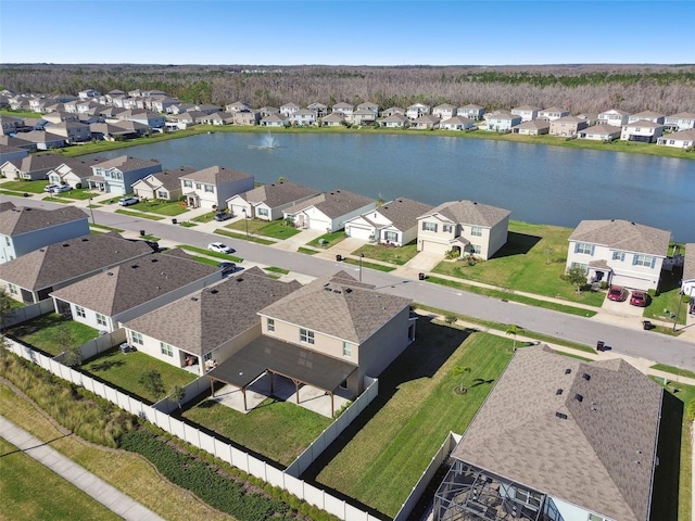 drone / aerial view with a water view and a residential view