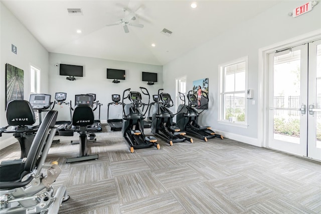 workout area with light colored carpet, vaulted ceiling, visible vents, and baseboards