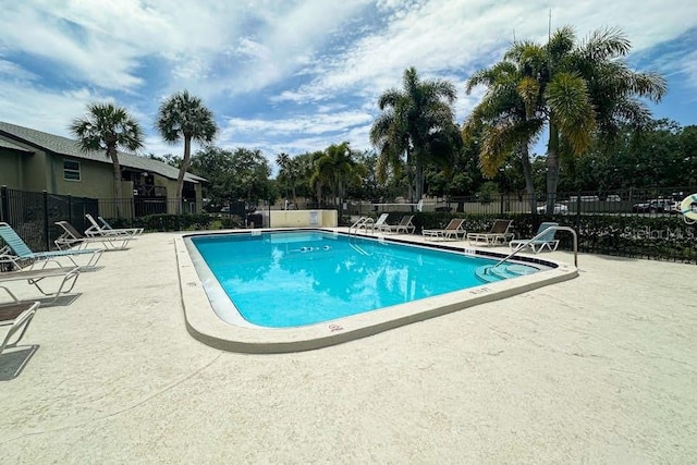 pool featuring a patio area and fence