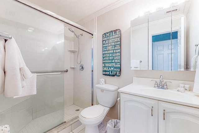 full bath featuring ornamental molding, a stall shower, vanity, and toilet