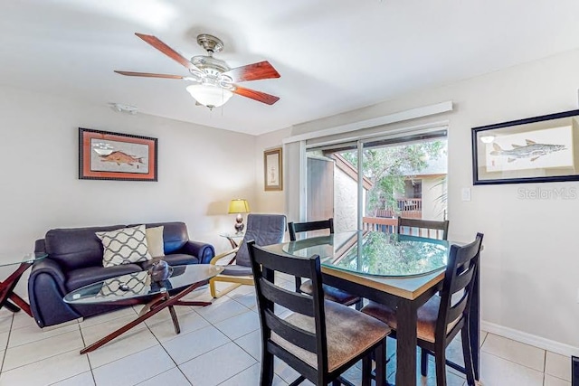 dining room with ceiling fan, light tile patterned flooring, and baseboards