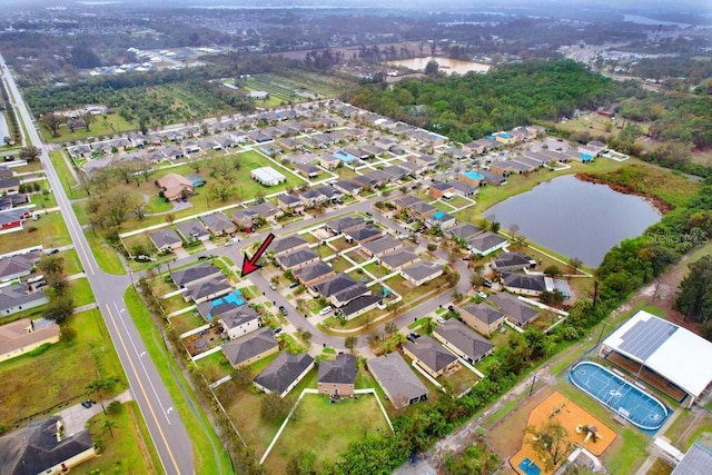 bird's eye view with a residential view and a water view