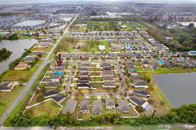 bird's eye view featuring a residential view and a water view