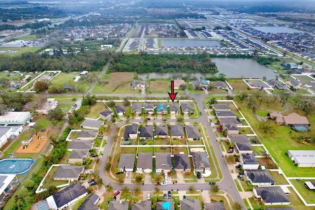 drone / aerial view featuring a residential view and a water view