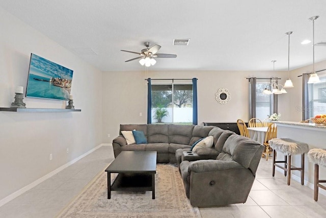 living room featuring visible vents, plenty of natural light, baseboards, and light tile patterned floors