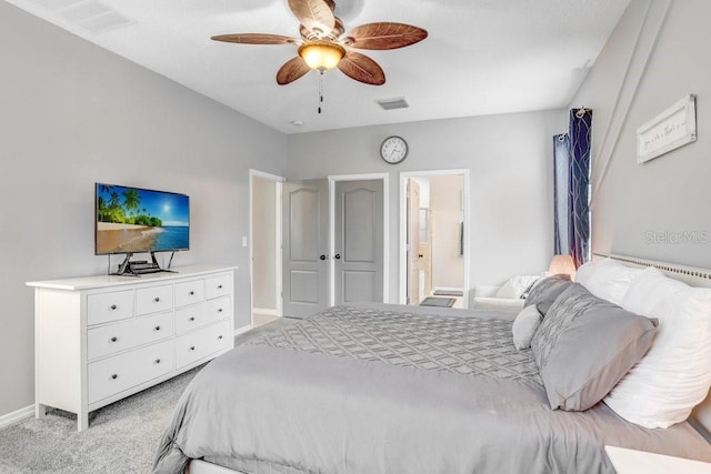 bedroom with visible vents, a ceiling fan, light carpet, connected bathroom, and baseboards