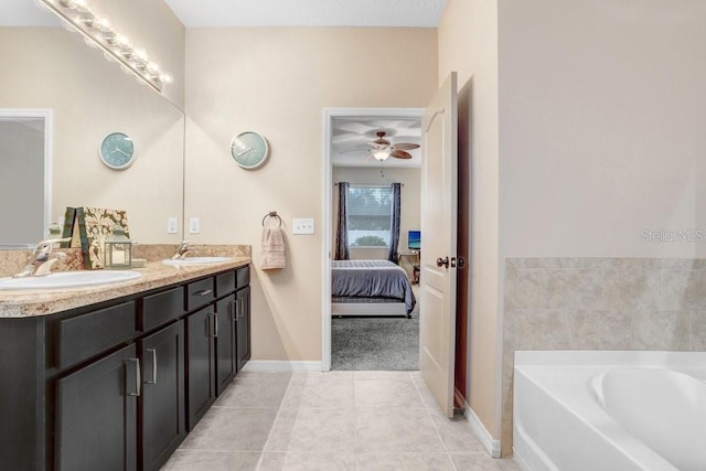 ensuite bathroom featuring a sink, double vanity, ensuite bath, and tile patterned floors