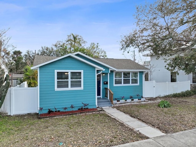 bungalow with roof with shingles and fence