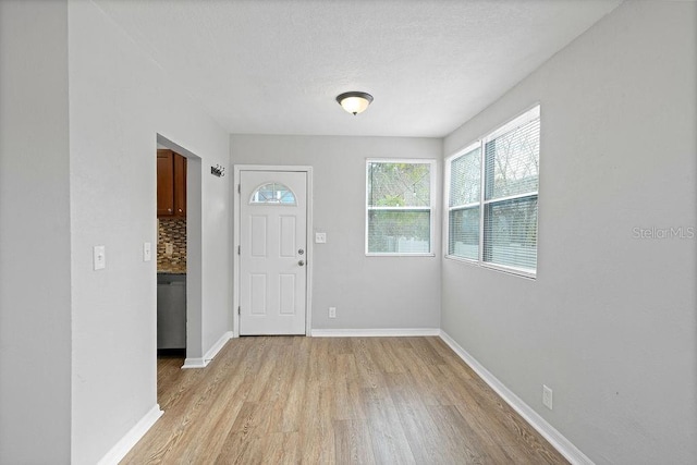 entrance foyer with light wood-type flooring and baseboards