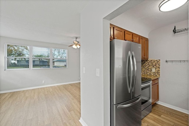 kitchen featuring tasteful backsplash, baseboards, brown cabinetry, light wood-style flooring, and stainless steel appliances