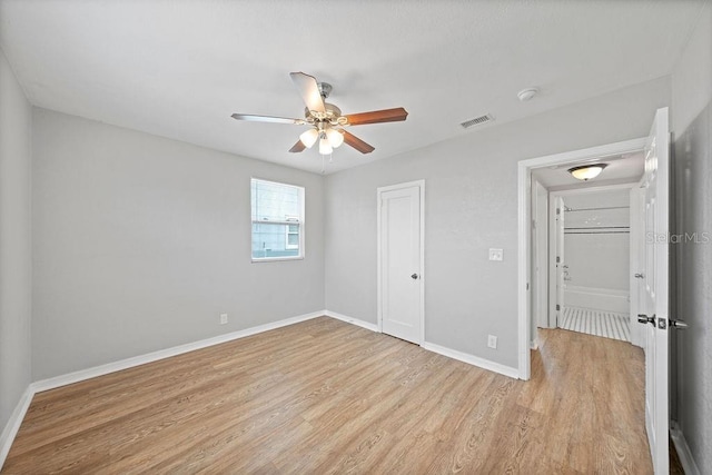 unfurnished bedroom featuring a closet, visible vents, light wood-style floors, a ceiling fan, and baseboards