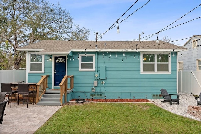 view of front facade with a patio area, crawl space, a front yard, and fence