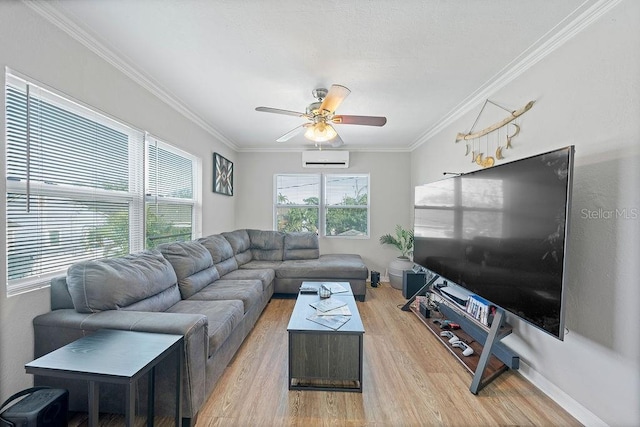 living area featuring ornamental molding, a wall unit AC, plenty of natural light, and light wood-style flooring