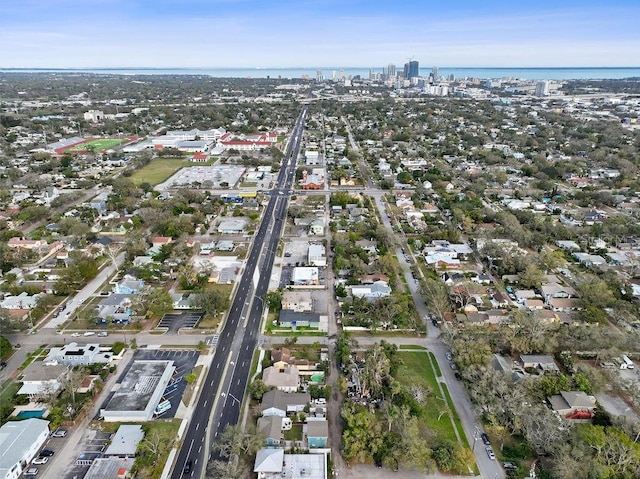 birds eye view of property featuring a water view and a city view