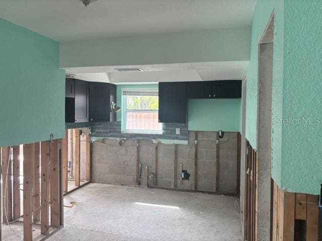 kitchen featuring dark cabinetry