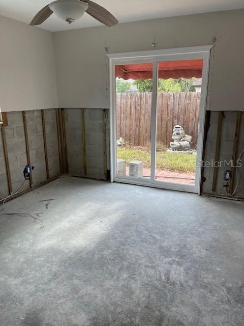 empty room featuring unfinished concrete flooring and a ceiling fan