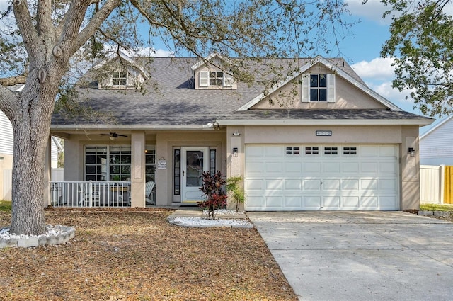 view of front facade featuring a garage, concrete driveway, roof with shingles, a porch, and stucco siding