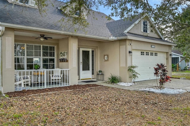 view of front of house with an attached garage, stucco siding, and roof with shingles