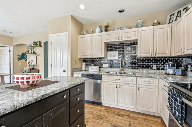 kitchen featuring decorative backsplash, electric range oven, dishwasher, light stone countertops, and light wood-style floors