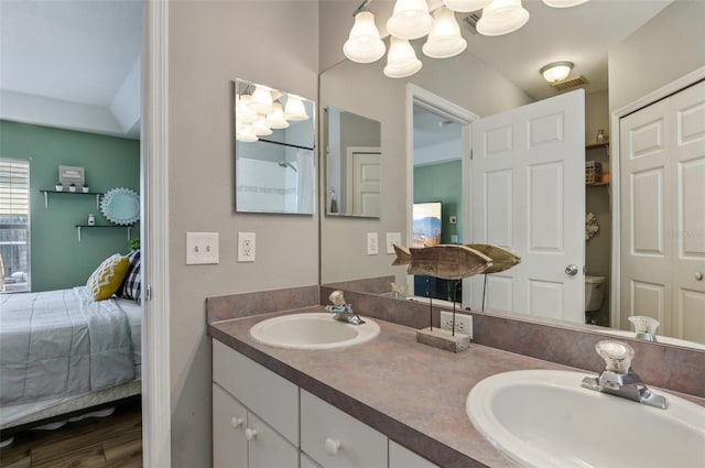 bathroom featuring visible vents, a sink, ensuite bath, and double vanity