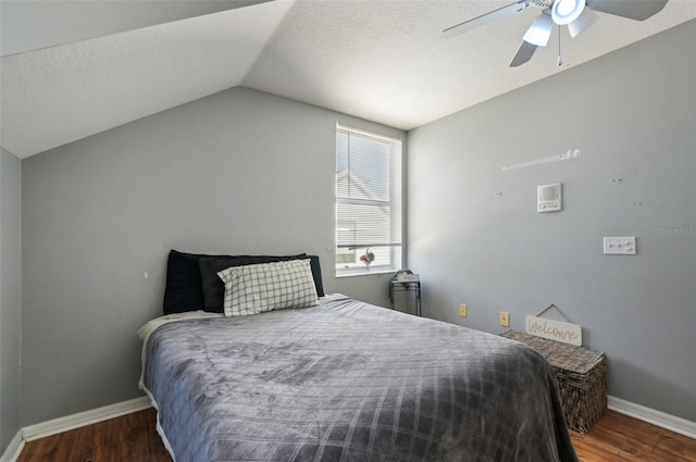 bedroom featuring lofted ceiling, dark wood-style flooring, and baseboards