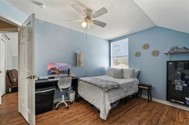 bedroom with lofted ceiling, dark wood-style flooring, a ceiling fan, and baseboards