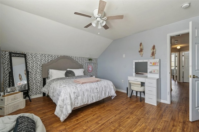 bedroom with dark wood-type flooring, lofted ceiling, baseboards, and a ceiling fan