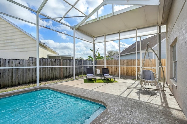 view of pool with a fenced in pool, a lanai, a patio area, and a fenced backyard