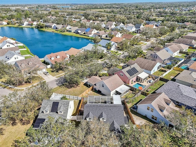 drone / aerial view with a water view and a residential view