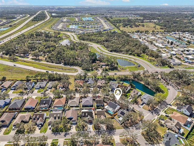 drone / aerial view featuring a residential view and a water view