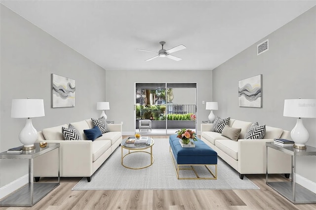 living room with ceiling fan, wood finished floors, visible vents, and baseboards