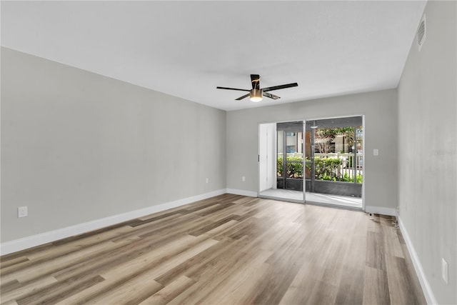 unfurnished room with ceiling fan, baseboards, and wood finished floors