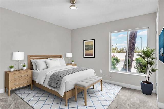 bedroom with light carpet and baseboards