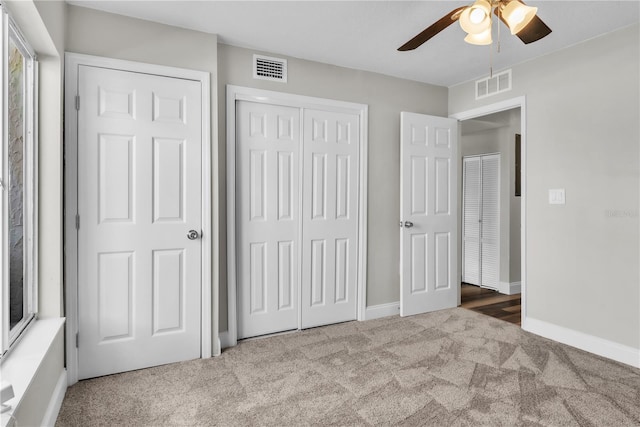 unfurnished bedroom featuring baseboards, a closet, visible vents, and carpet flooring