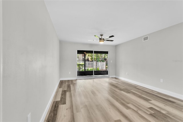 unfurnished room featuring visible vents, ceiling fan, baseboards, and wood finished floors