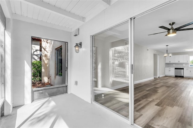 unfurnished sunroom featuring wooden ceiling, beamed ceiling, and ceiling fan with notable chandelier