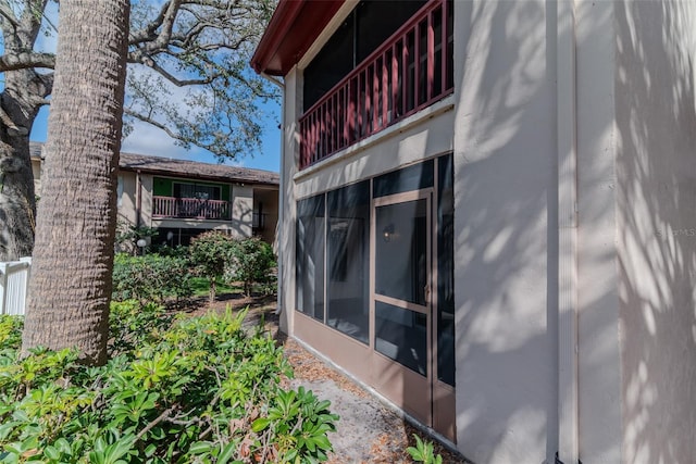 view of home's exterior with a balcony and stucco siding