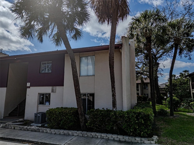 exterior space featuring central air condition unit and stucco siding