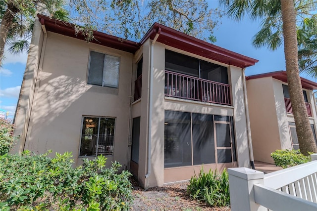 8640 Tahoe Ct Unit 16, Tampa, FL 33614 - back of house featuring stucco siding and a sunroom