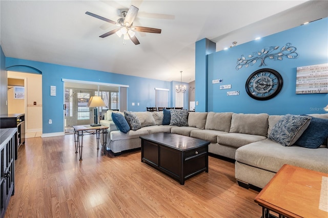 living room featuring light wood-style floors and ceiling fan with notable chandelier