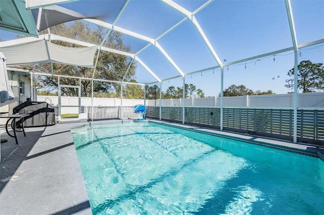 view of swimming pool with a fenced in pool, a fenced backyard, glass enclosure, and a patio area