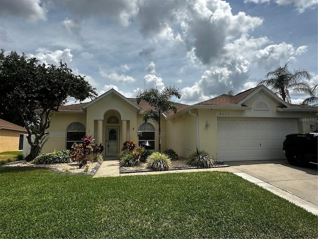 view of front of property featuring driveway, a garage, a front lawn, a shingled roof, and stucco siding