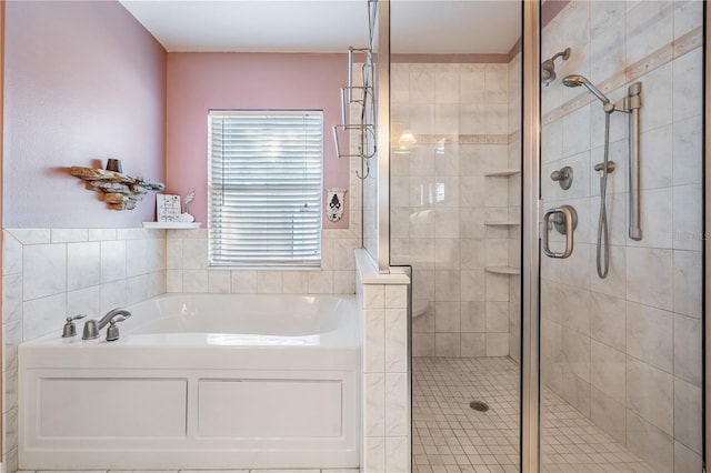 bathroom featuring a bath and a stall shower