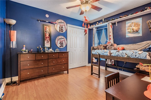 bedroom with baseboards, a ceiling fan, and wood finished floors