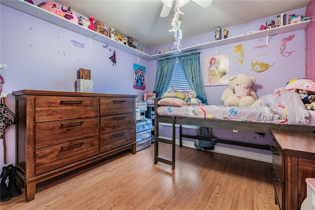 bedroom featuring a ceiling fan and light wood finished floors