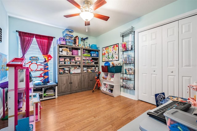 game room with ceiling fan and wood finished floors